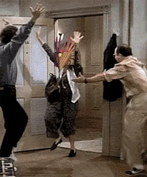 A Group Of People Are Dancing In A Hallway With A Woman Wearing A Feathered Headpiece