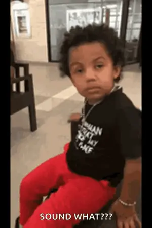 A Young Boy Is Sitting On A Bench In A Hospital Waiting Room .