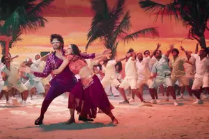 A Group Of People Are Dancing On The Beach