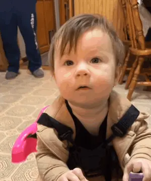 A Baby Is Wearing A Brown Jacket And A Black Shirt With The Word Aqua On The Pants