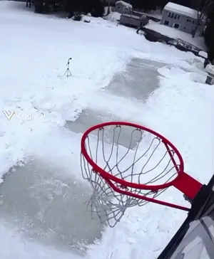 A Picture Of A Basketball Hoop In The Snow With A Viggle.Ai Watermark